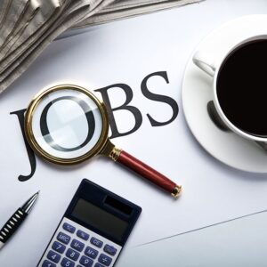 title jobs with loupe, pen, newspapers, cup of coffee and calculator